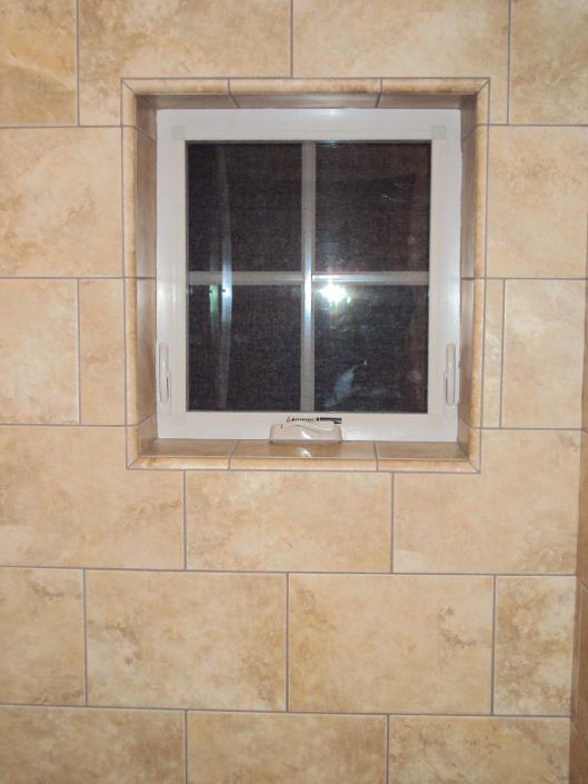 remodeled tile shower with vinyl window